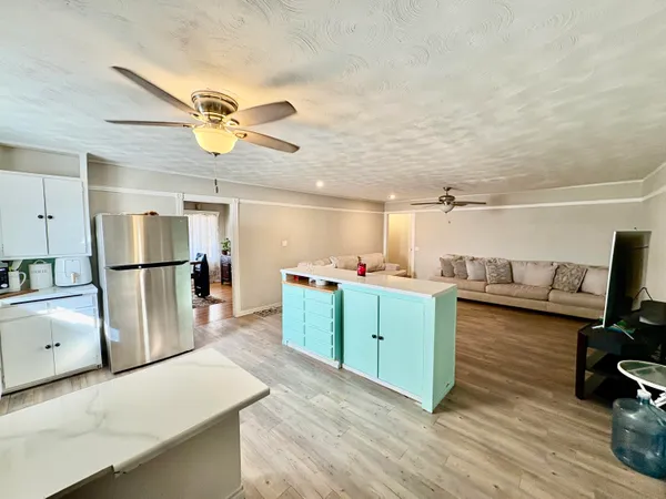 a kitchen with cabinets and wooden floor
