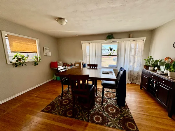 a view of a dining room with furniture window and wooden floor