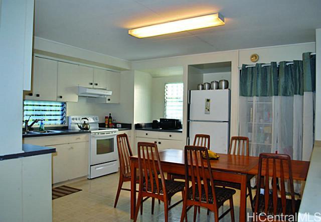2214 Pauoa Road Honolulu, HI 96813 - Photo 1 of 1 a kitchen with stainless steel appliances granite countertop a dining table chairs and a refrigerator