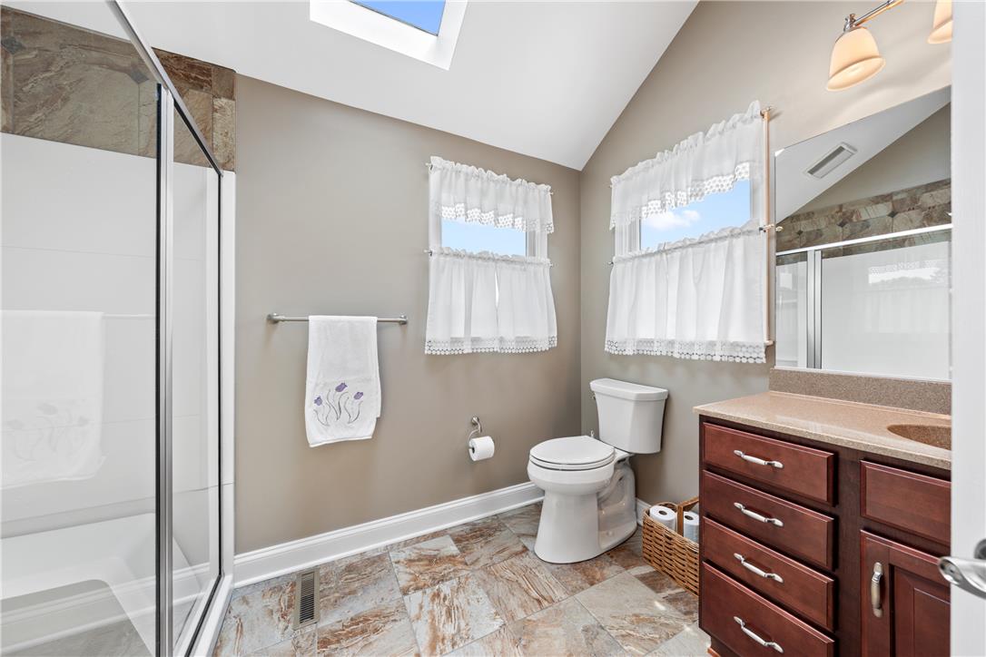 4568 Greenfield Road Bethlehem, PA 18017 - Photo 25 of 59 Natural light floods this well-appointed bathroom featuring a spacious shower and ample storage.