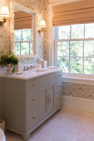 a bathroom with a sink and a window