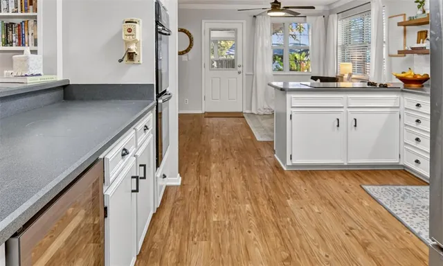 a view of hallway with wooden floor and staircase