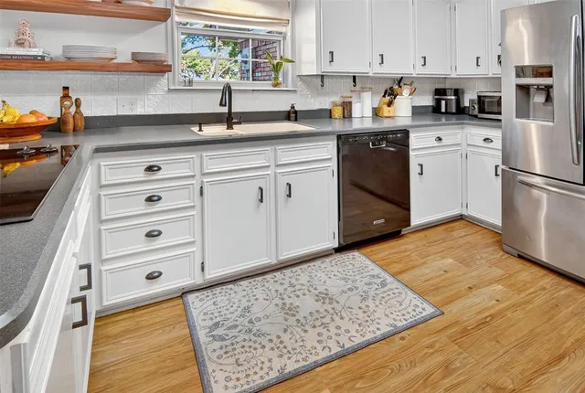 a kitchen with cabinets appliances and a counter space