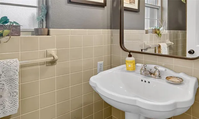 a bathroom with a sink and mirror