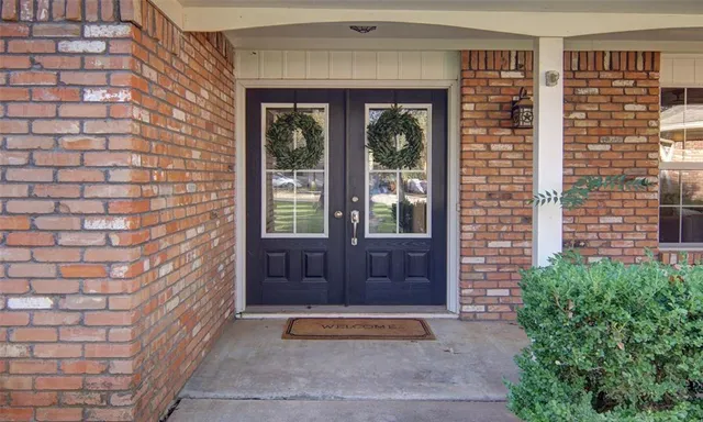 a view of front door of house with stairs
