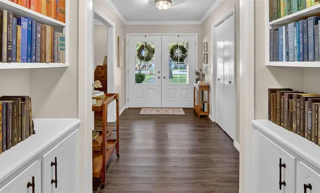 a view of a hallway with wooden floor and dining room view