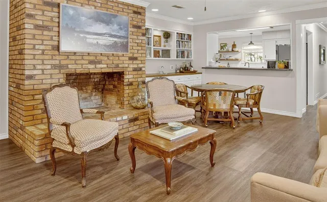 a dining room with furniture and wooden floor