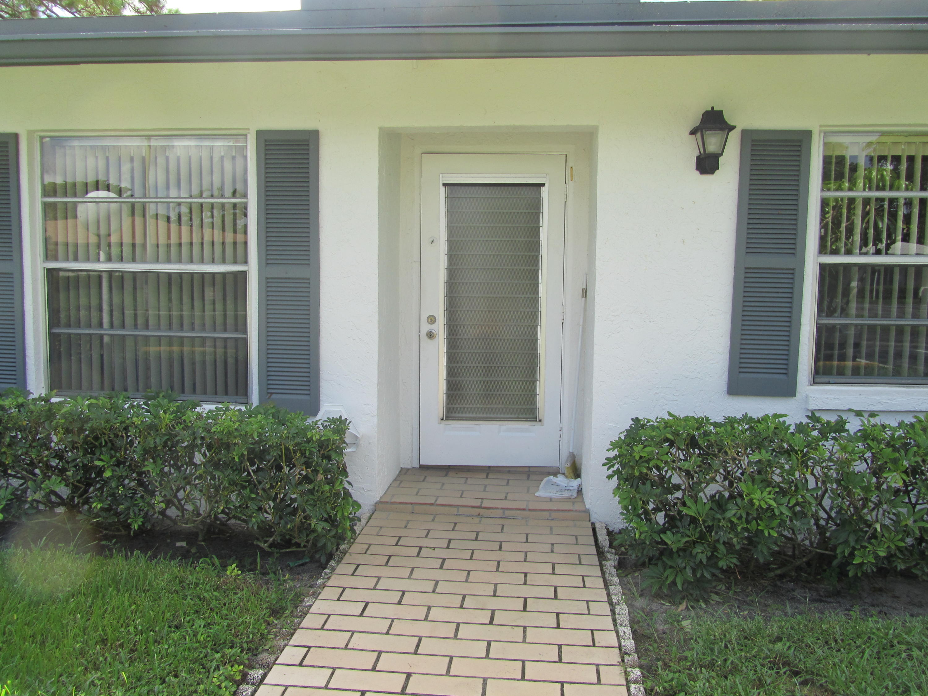 5368 Privet Place, Unit B Delray Beach, FL 33484 - Photo 2 of 15 a front view of a house with a yard