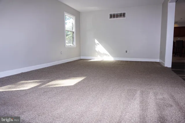 a kitchen with stainless steel appliances granite countertop a sink table and chairs