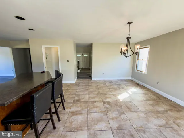 a view of empty room with wooden floor and fireplace
