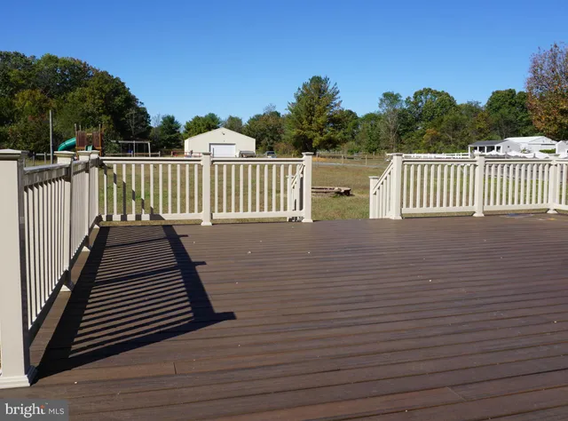 a view of a house with a large space and a car parked in front of it