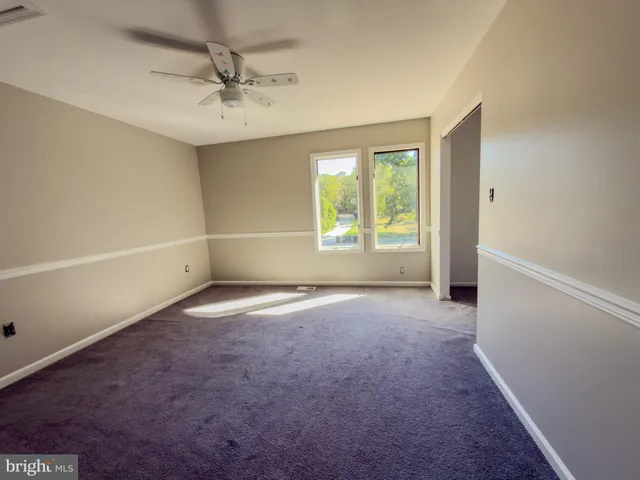 an empty room with a empty space and windows