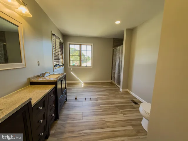 a view of a hallway with workspace and stairs