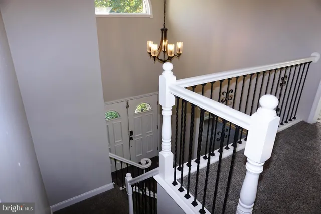 a view of a big room with windows and entryway