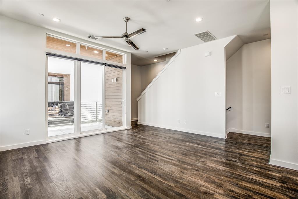 2190 Bennett Avenue, Unit 301 Dallas, TX 75206 - Photo 5 of 21 a view of an empty room with wooden floor and a window