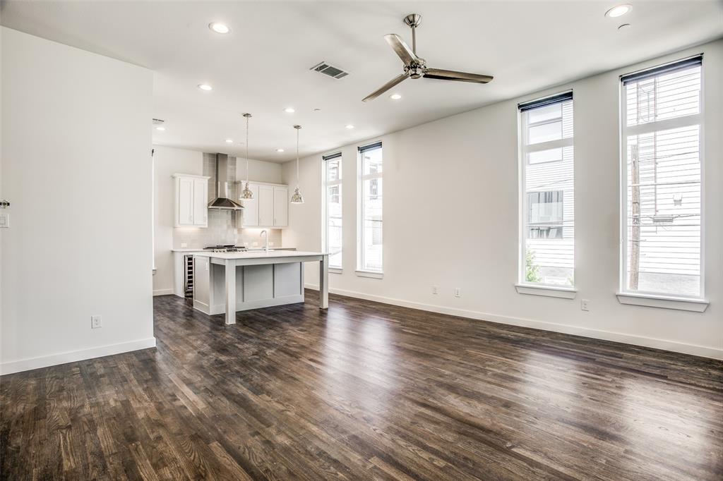 2190 Bennett Avenue, Unit 301 Dallas, TX 75206 - Photo 9 of 21 a view of an empty room with wooden floor and a window