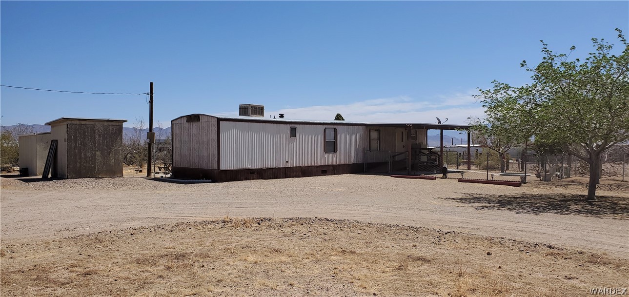 524 South Eden Road Golden Valley, AZ 86413 - Photo 2 of 32 a street view with a wooden fence