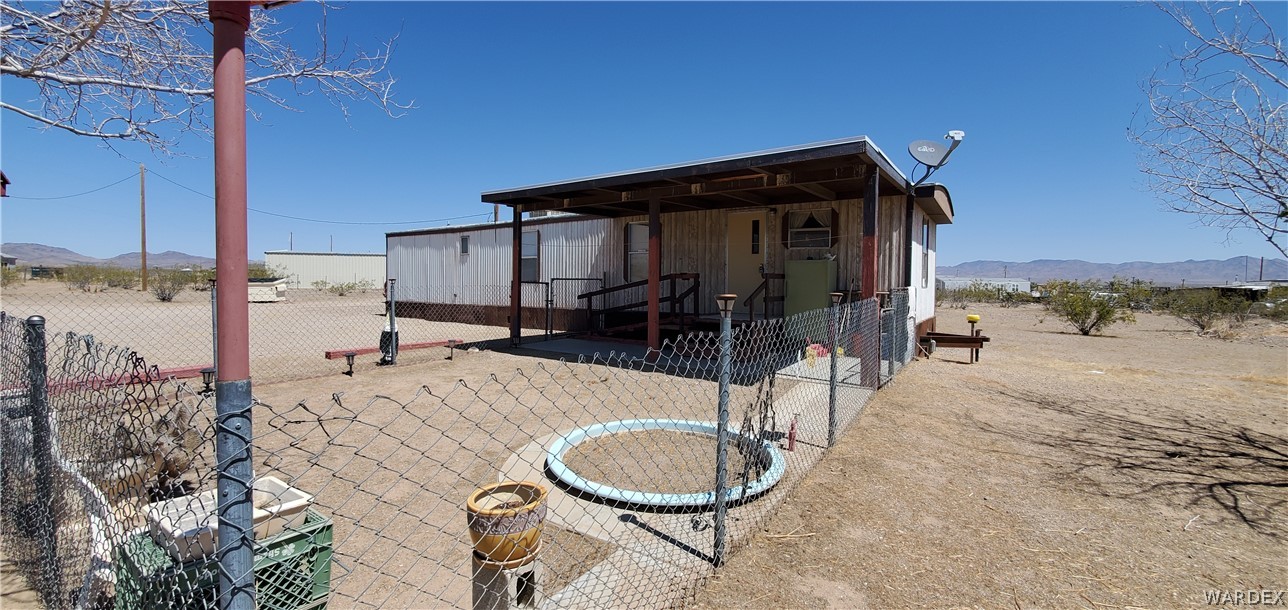 524 South Eden Road Golden Valley, AZ 86413 - Photo 9 of 32 a backyard of a house with yard and outdoor seating