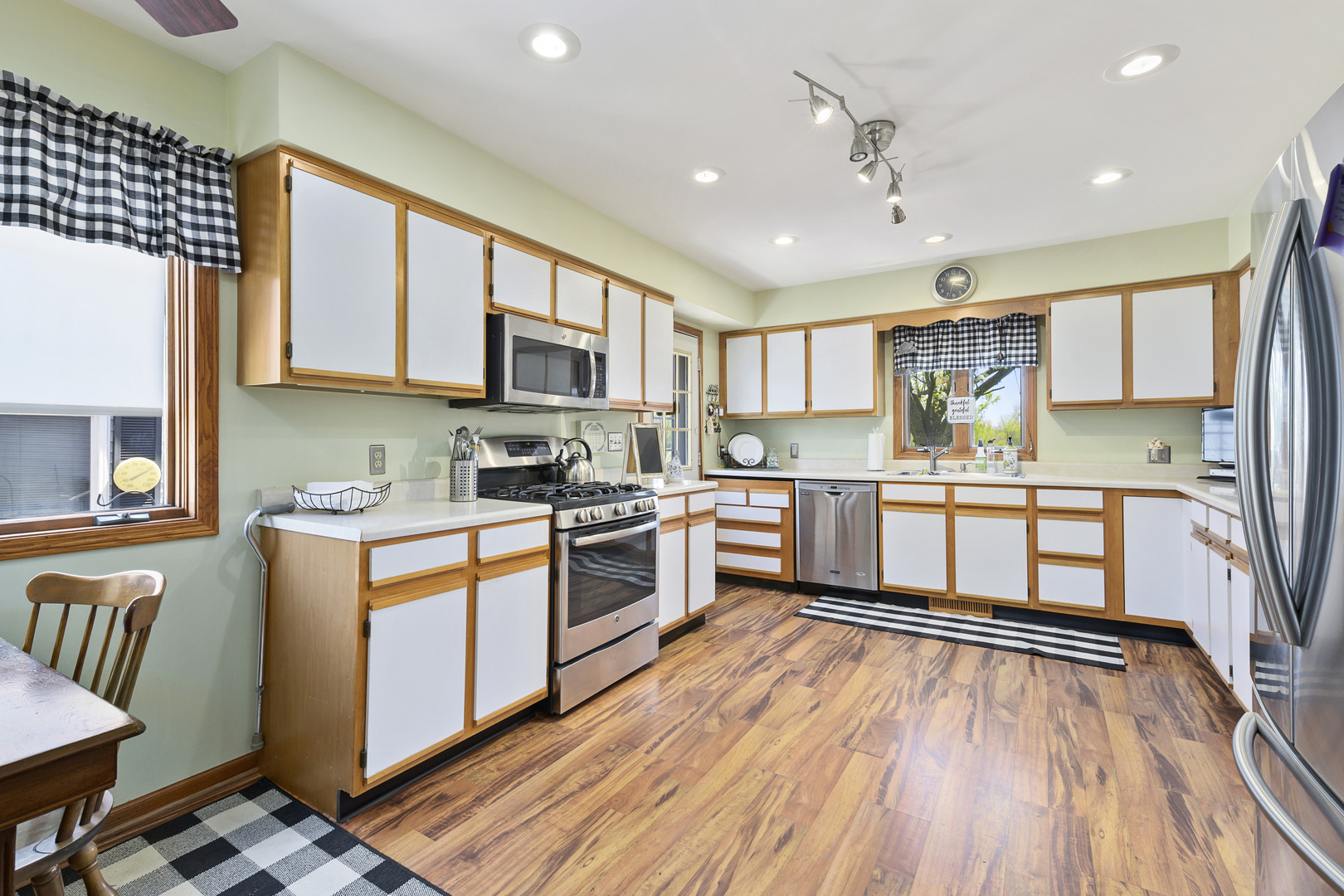 3205 Caton Farm Road Joliet, IL 60431 - Photo 3 of 20 a kitchen with stainless steel appliances granite countertop a stove top oven a sink dishwasher and a refrigerator with wooden floor