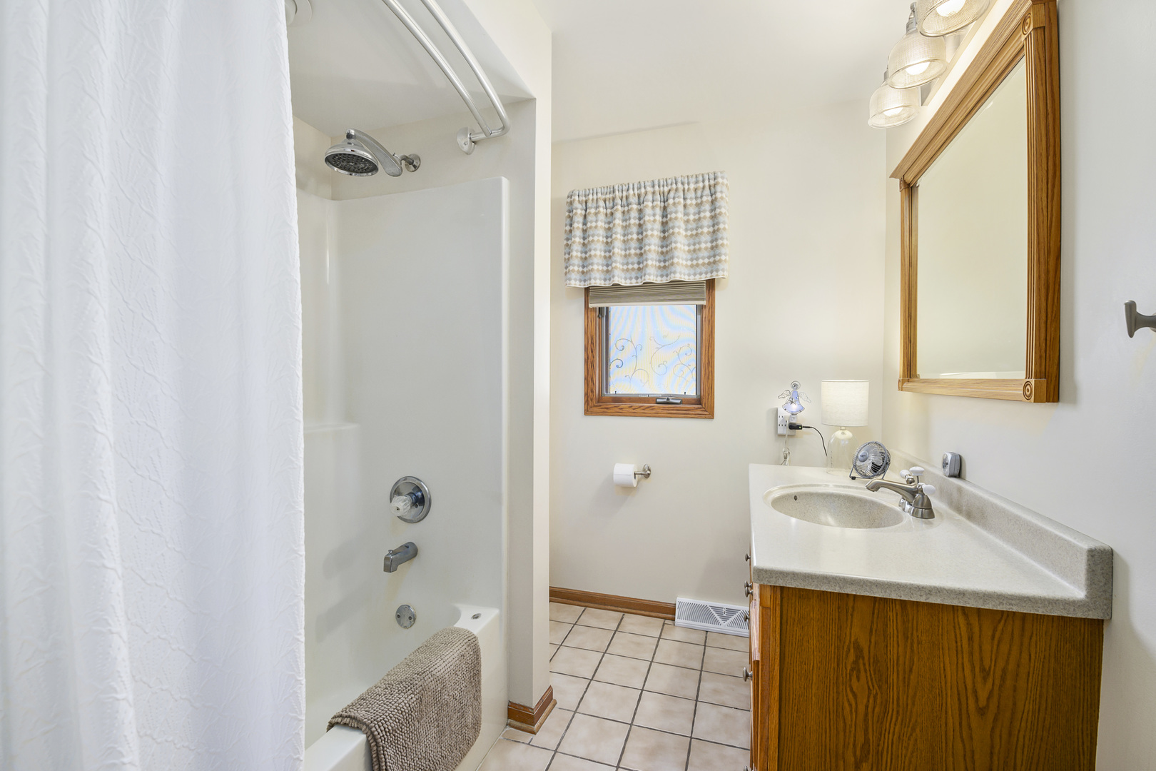 3205 Caton Farm Road Joliet, IL 60431 - Photo 5 of 20 a bathroom with a sink a toilet and shower