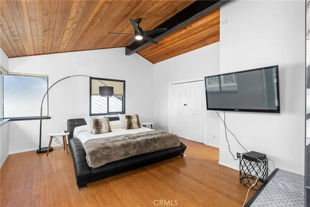 a living room with a bed furniture and a flat screen tv