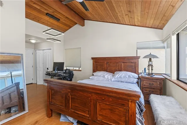 a bedroom with a bed a flat screen tv and dresser