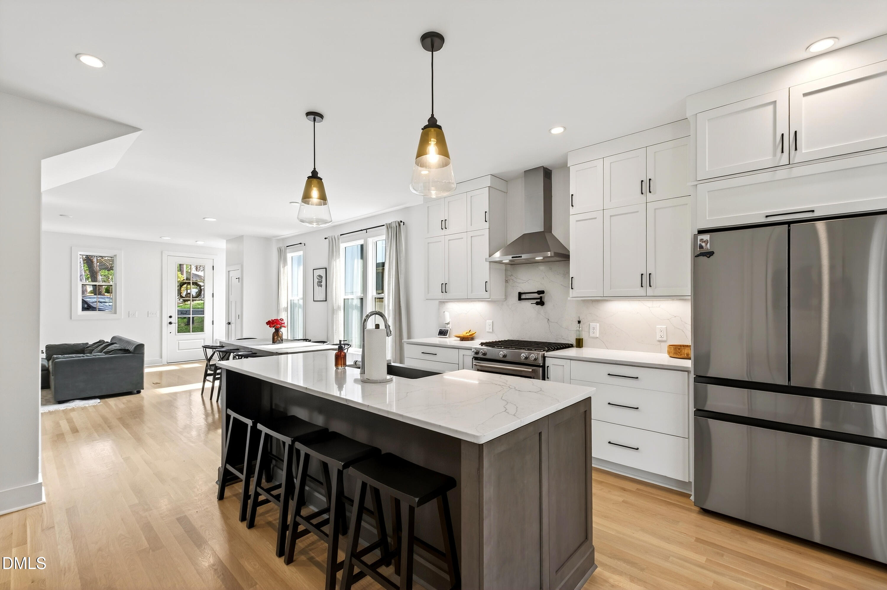 325 Grand Avenue Raleigh, NC 27606 - Photo 16 of 46 a kitchen with refrigerator cabinets dining table and chairs