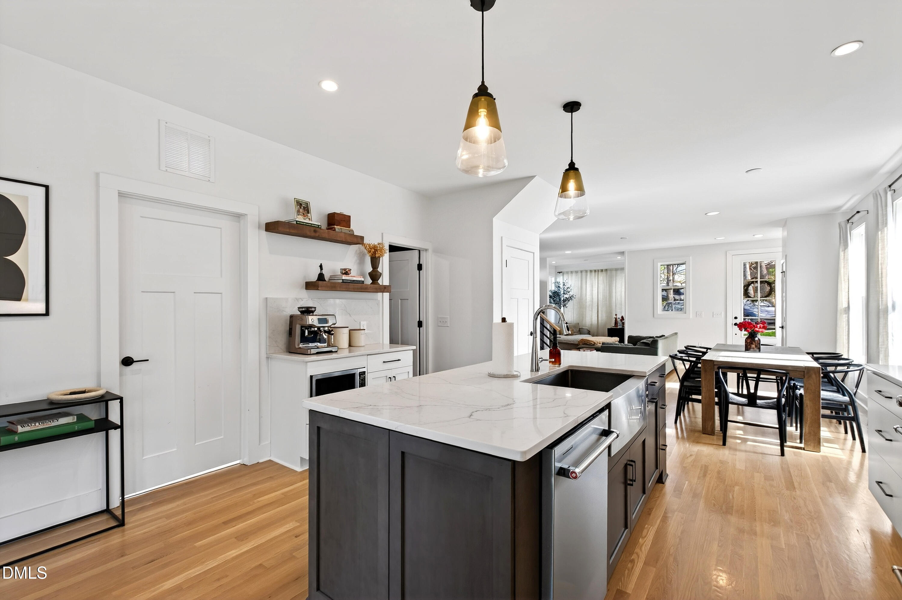 325 Grand Avenue Raleigh, NC 27606 - Photo 19 of 46 a view of a dining room and livingroom with furniture wooden floor a chandelier