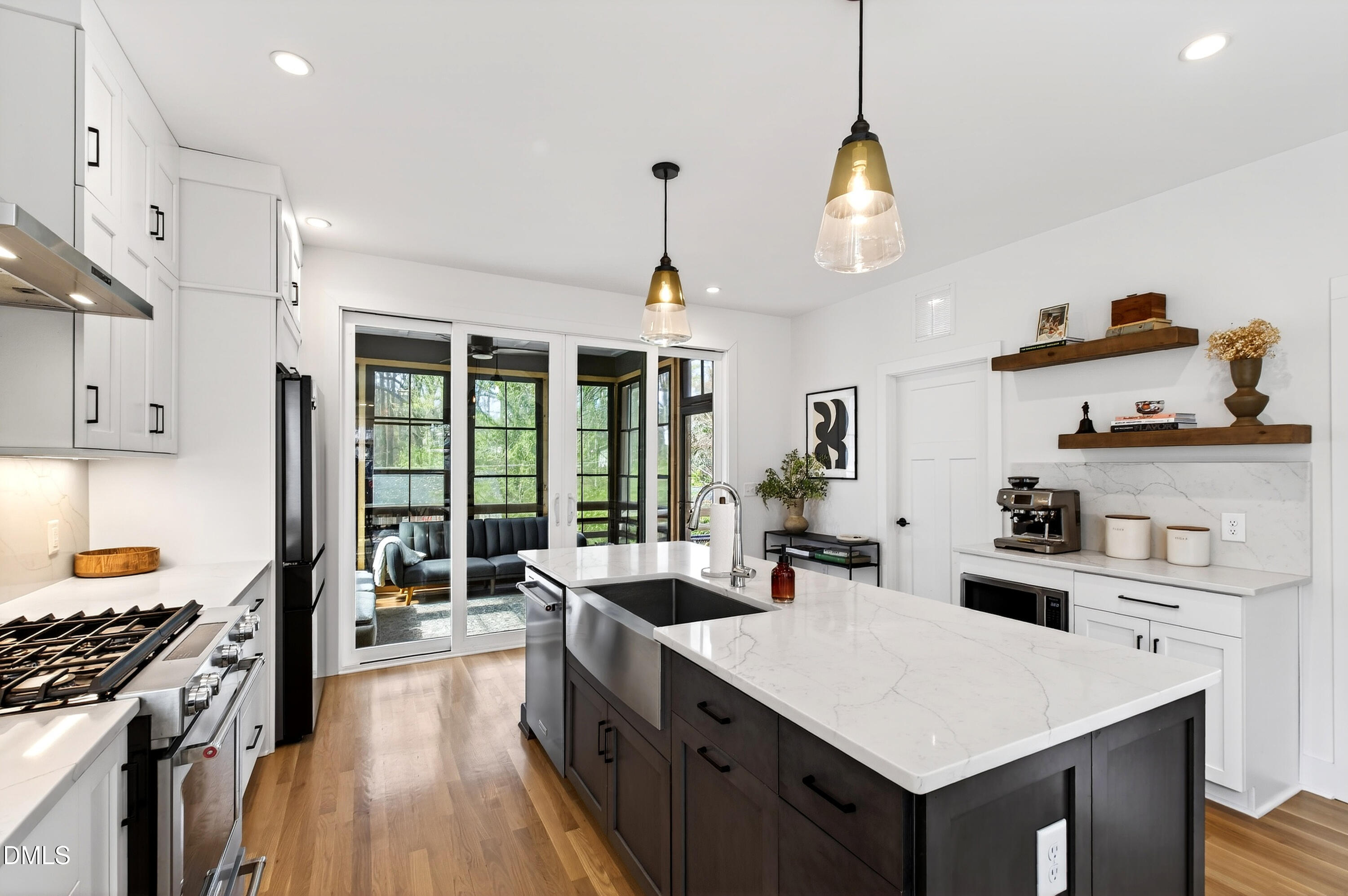 325 Grand Avenue Raleigh, NC 27606 - Photo 20 of 46 a kitchen with kitchen island a sink stove and wooden floor