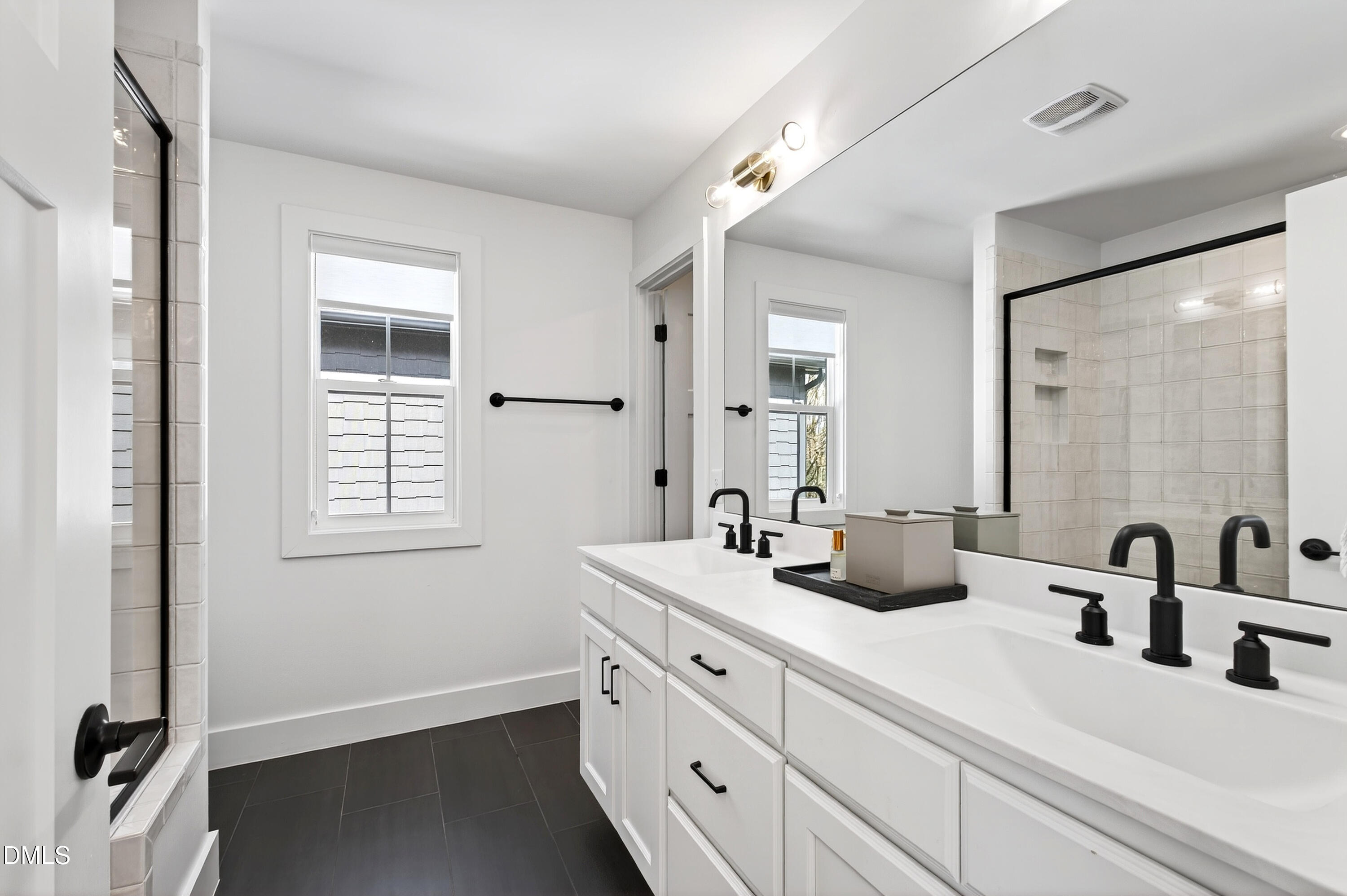 325 Grand Avenue Raleigh, NC 27606 - Photo 27 of 46 a bathroom with a double vanity sink and mirror with window