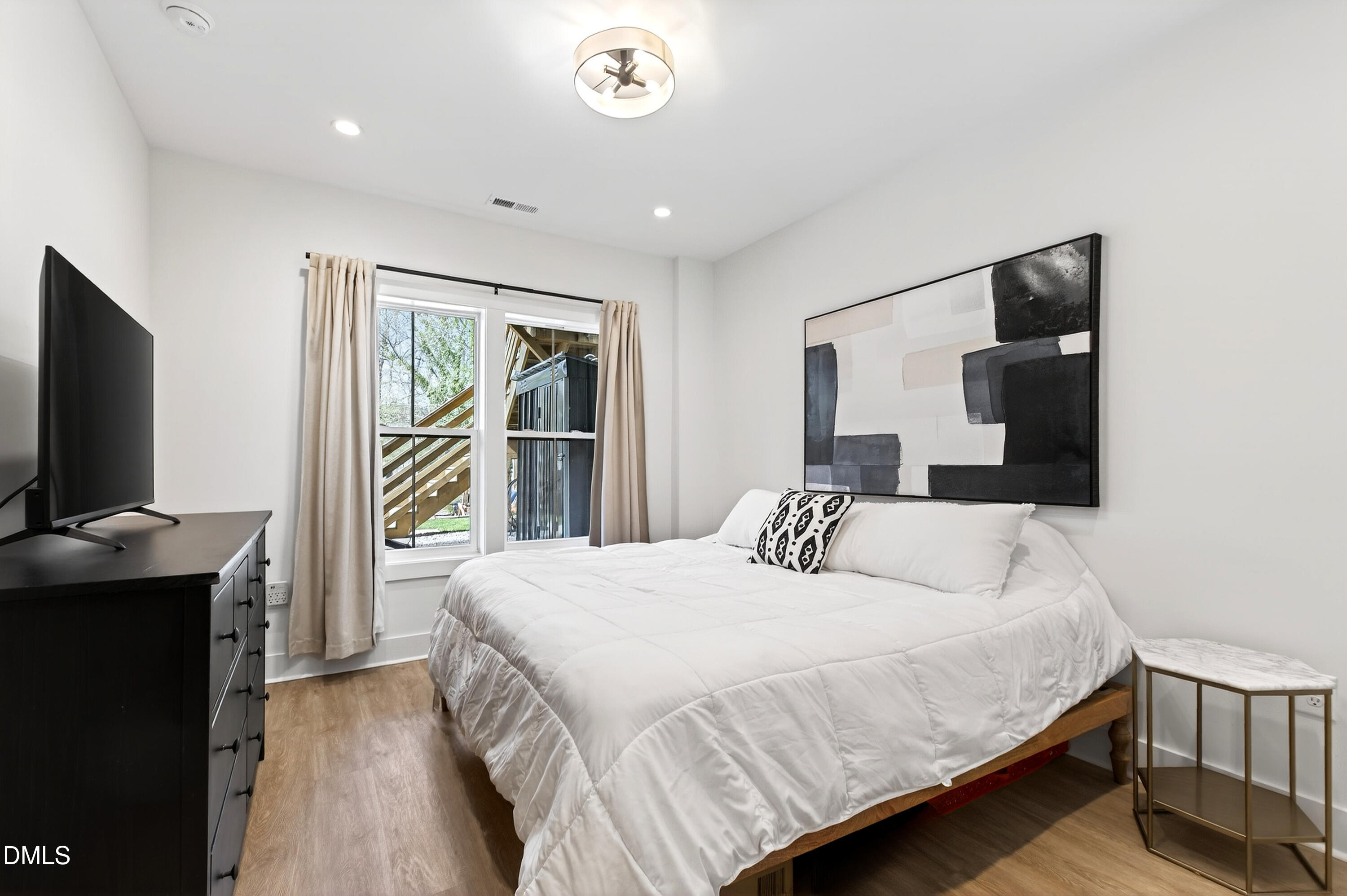 325 Grand Avenue Raleigh, NC 27606 - Photo 39 of 46 a bedroom with a bed and a flat screen tv