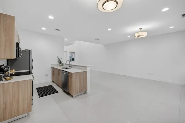 a kitchen with a sink and a refrigerator