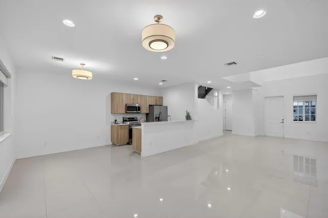 a view of a living room and kitchen