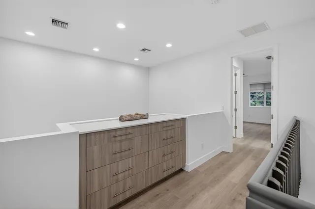 a view of a hallway with wooden floor