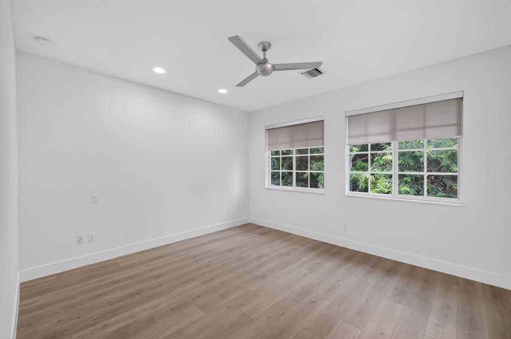 737 Southeast 1st Court, Unit 737 Pompano Beach, FL 33060 - Photo 25 of 53 a view of an empty room with wooden floor and a window