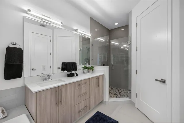 a bathroom with a tub sink and mirror