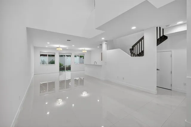 a view of a room with windows and cabinet