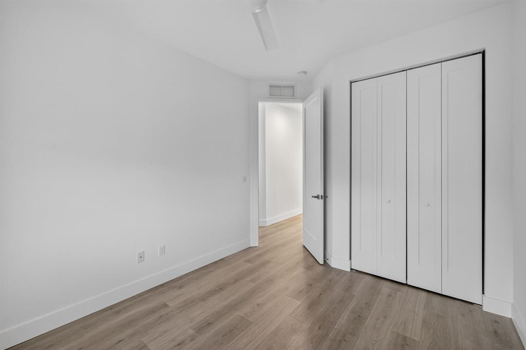 737 Southeast 1st Court, Unit 737 Pompano Beach, FL 33060 - Photo 34 of 53 a view of an empty room with wooden floor