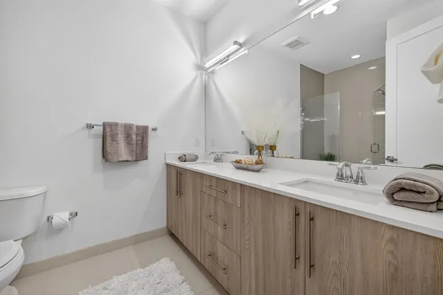 a bathroom with a shower a toilet and a shower