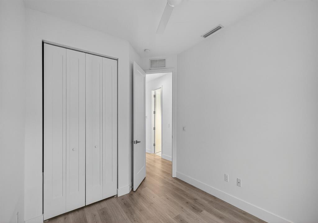 737 Southeast 1st Court, Unit 737 Pompano Beach, FL 33060 - Photo 38 of 53 a view of an empty room with wooden floor