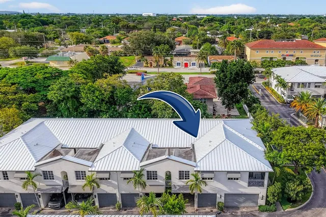 a view of a house with swimming pool and sitting area