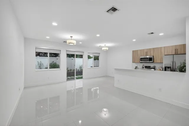 a kitchen with a refrigerator sink and stainless steel appliances