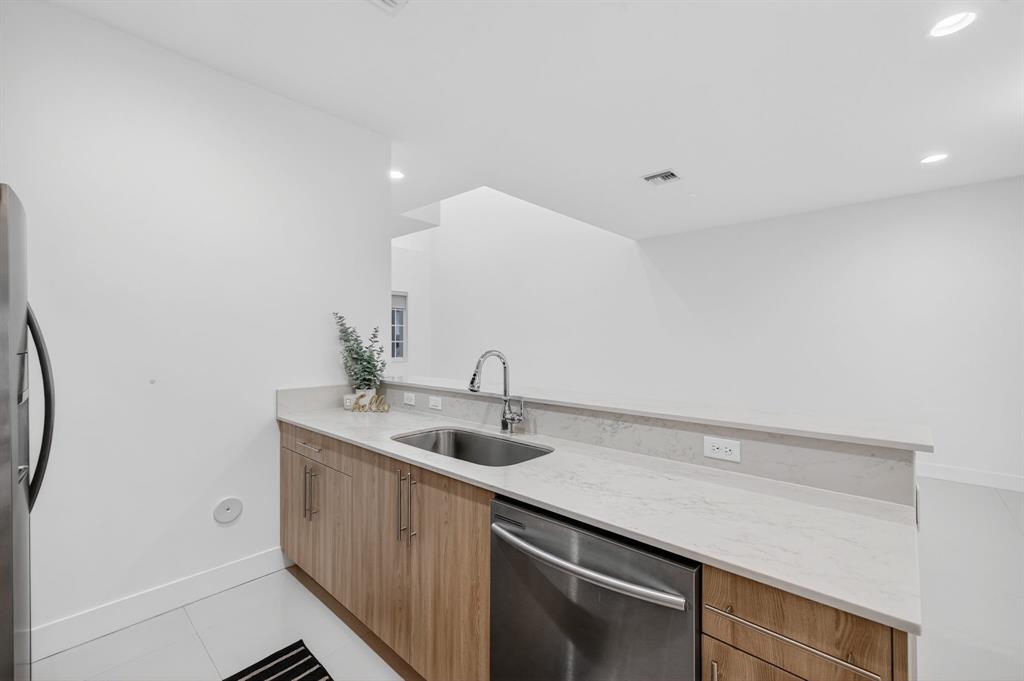 737 Southeast 1st Court, Unit 737 Pompano Beach, FL 33060 - Photo 10 of 53 a bathroom with a sink and a mirror