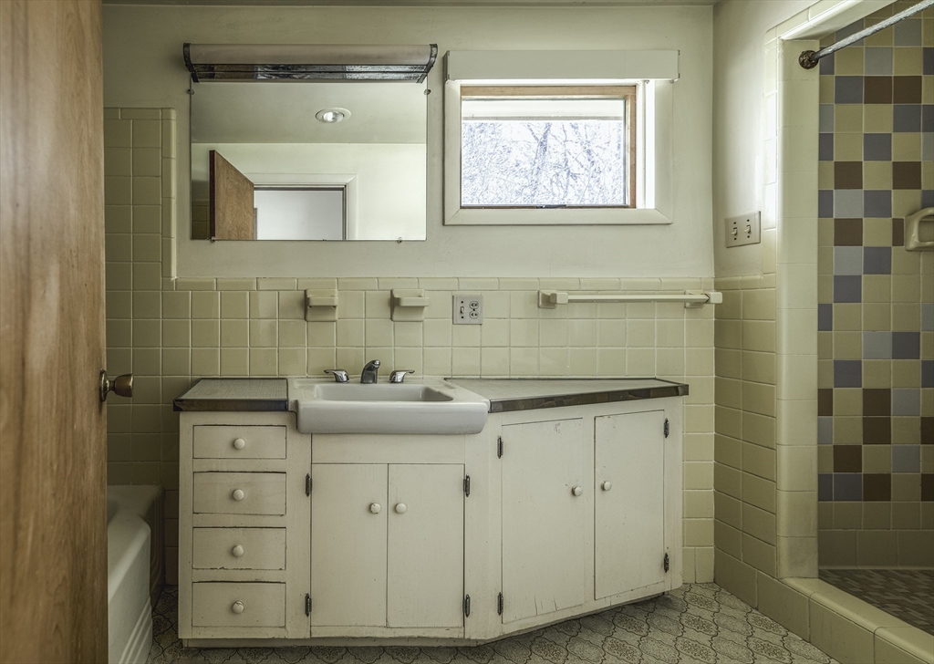 235 Argilla Road Ipswich, MA 01938 - Photo 14 of 28 a bathroom with a sink a vanity and a mirror