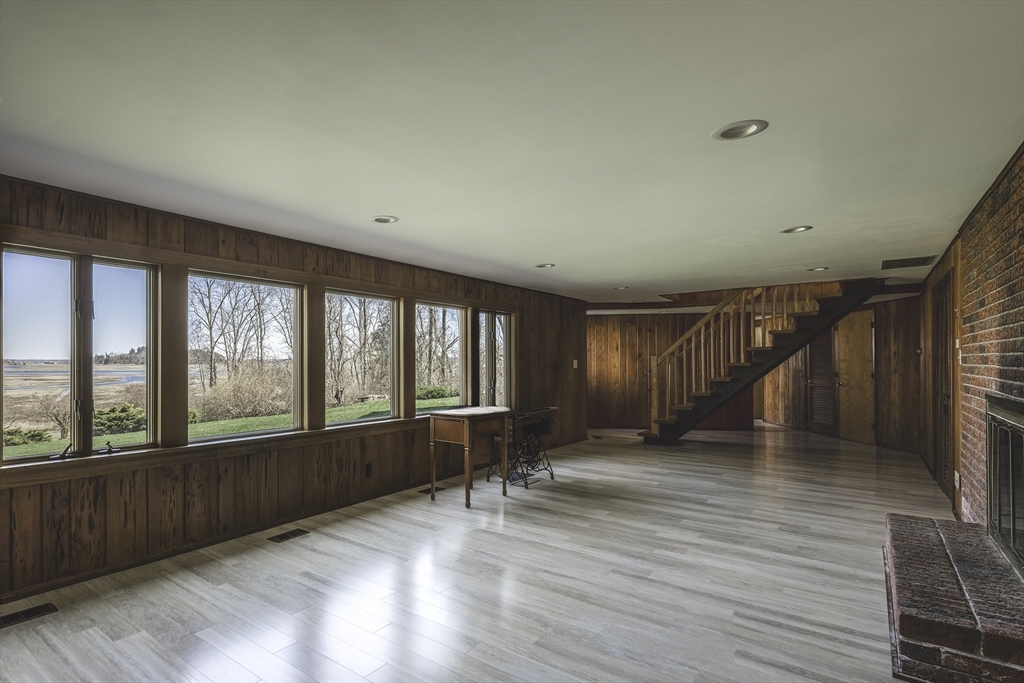 235 Argilla Road Ipswich, MA 01938 - Photo 17 of 28 a view of an empty room with a window and wooden floor