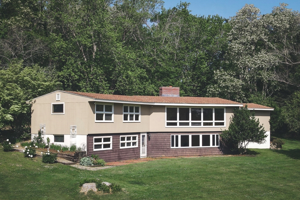 235 Argilla Road Ipswich, MA 01938 - Photo 3 of 28 a front view of a house with a garden and trees