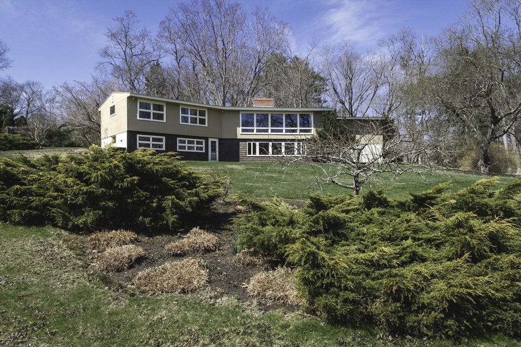 235 Argilla Road Ipswich, MA 01938 - Photo 5 of 28 a view of a house with a yard and sitting area