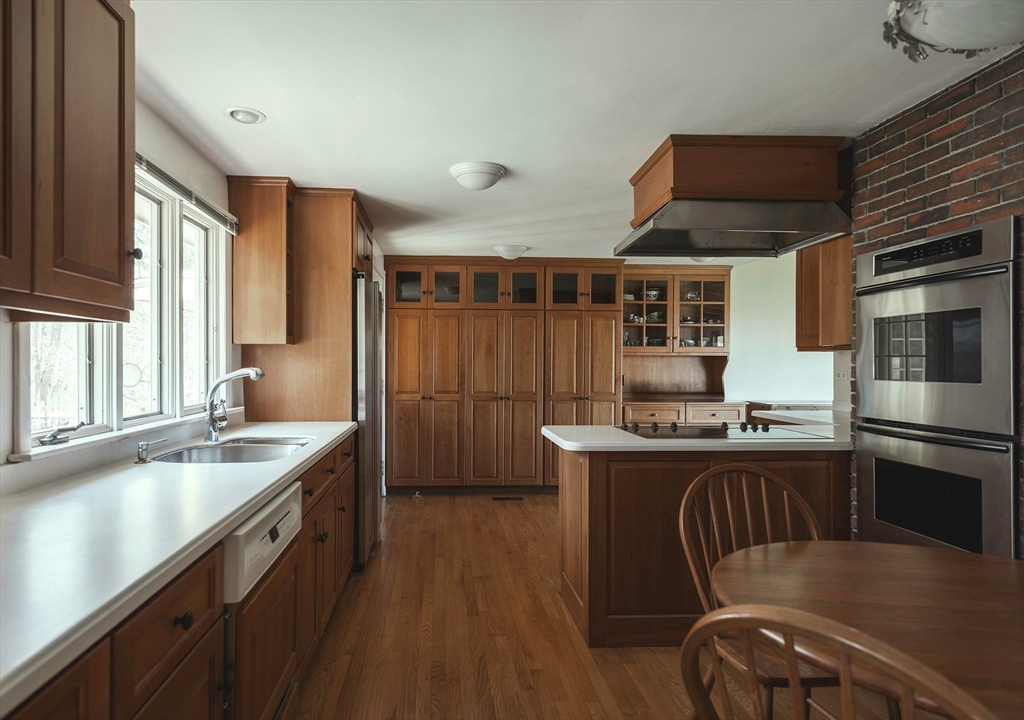 235 Argilla Road Ipswich, MA 01938 - Photo 7 of 28 a kitchen with stainless steel appliances granite countertop a sink a stove and a refrigerator