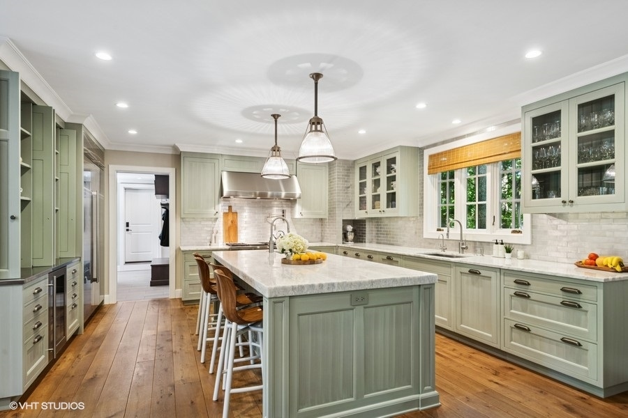 855 Sheridan Road Highland Park, IL 60035 - Photo 23 of 62 a kitchen that has a lot of cabinets in it and stainless steel appliances