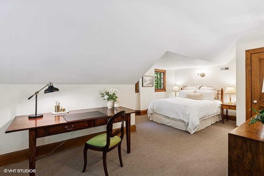 855 Sheridan Road Highland Park, IL 60035 - Photo 45 of 62 a bedroom with a bed table and chair